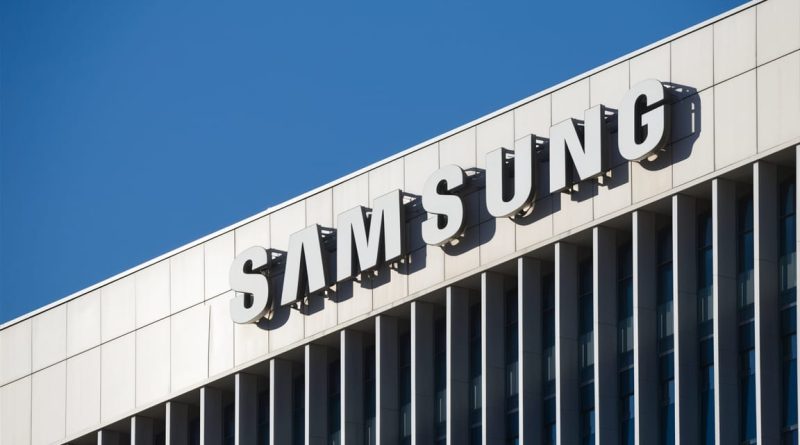 Samsung Electronics' headquarters with the company's logo on a modern building facade, showcasing sleek and futuristic design against a clear sky.